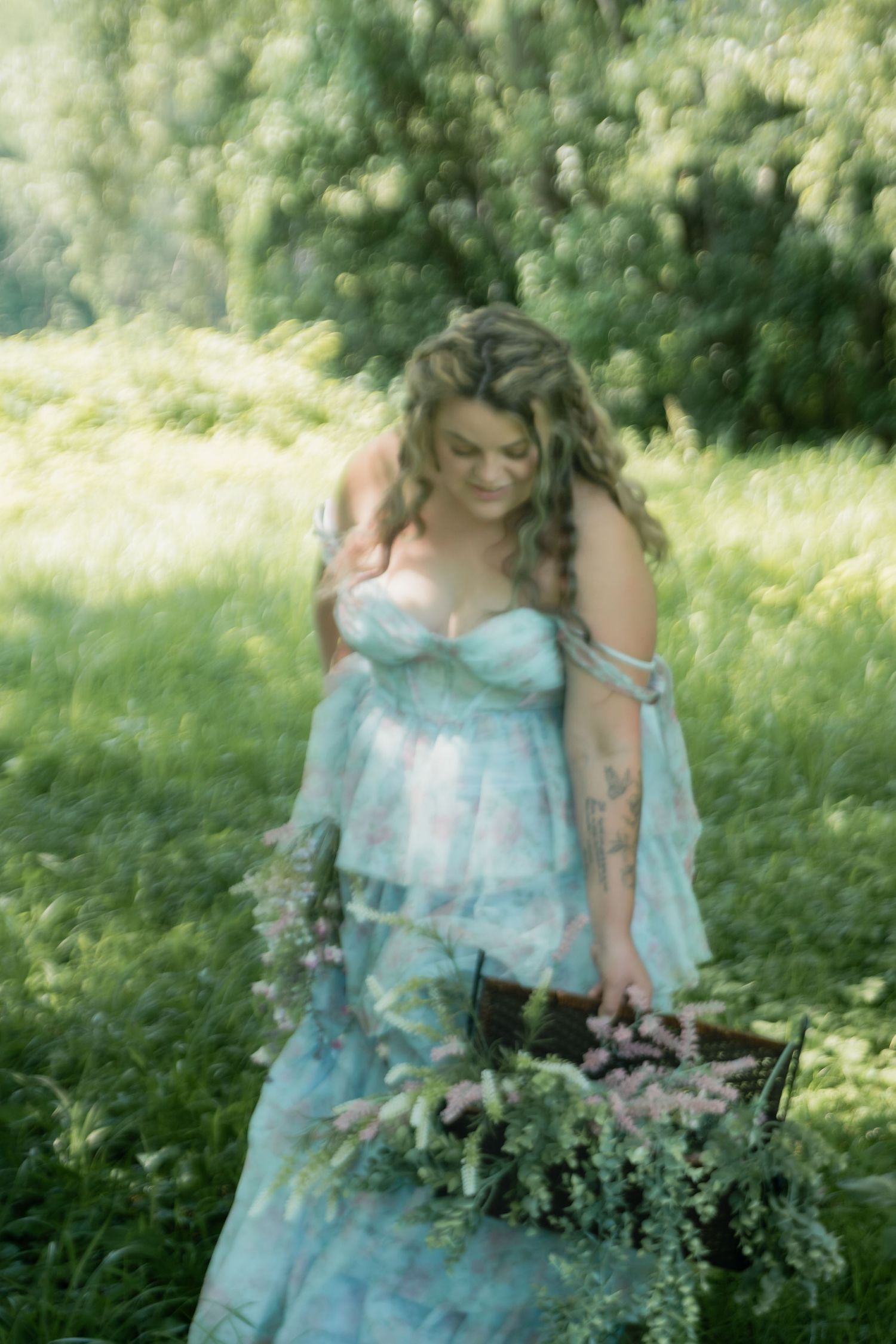 women looking at wildflower in a painterly bridal portrait in west elmira