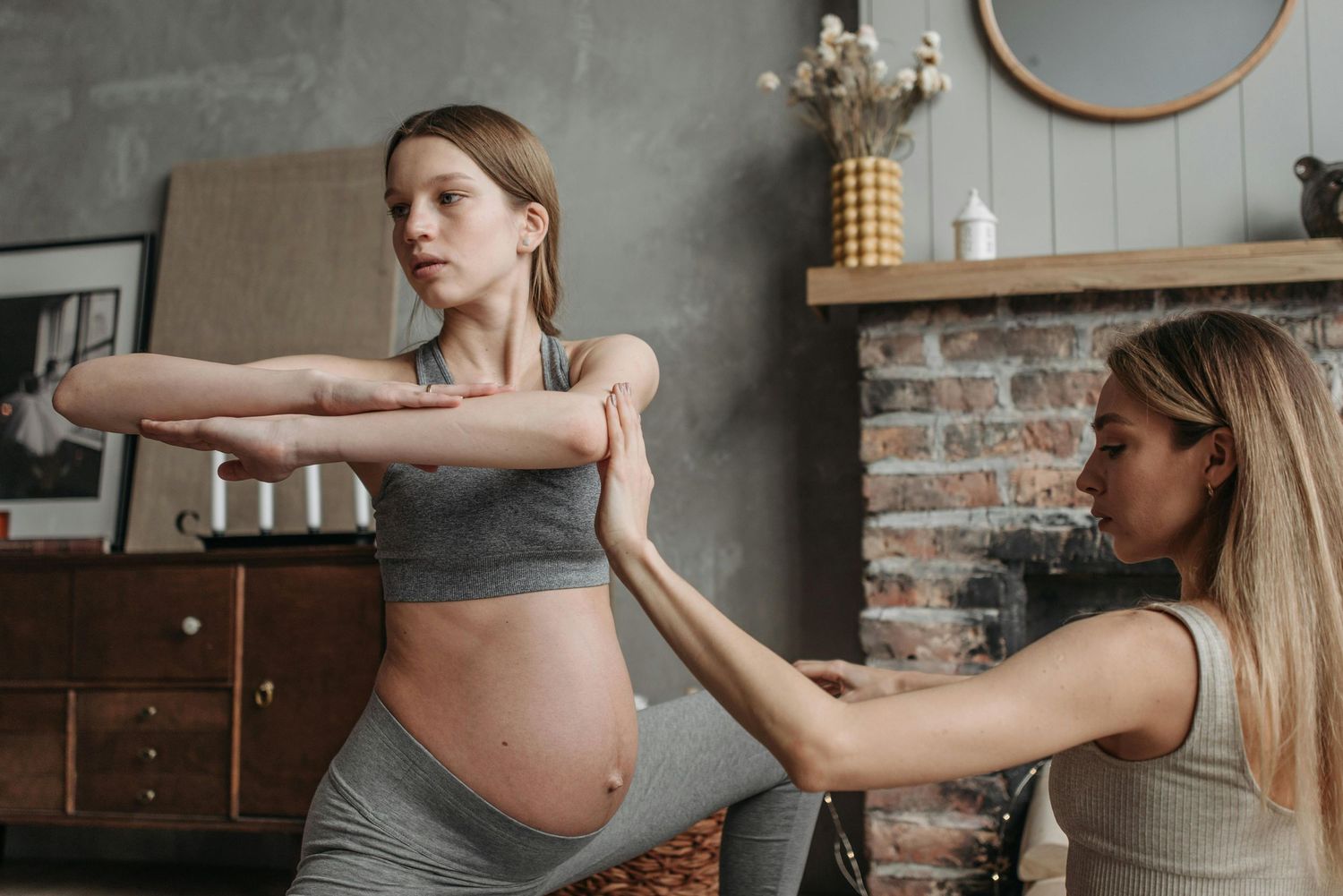 pregnant woman doing yoga with her doula