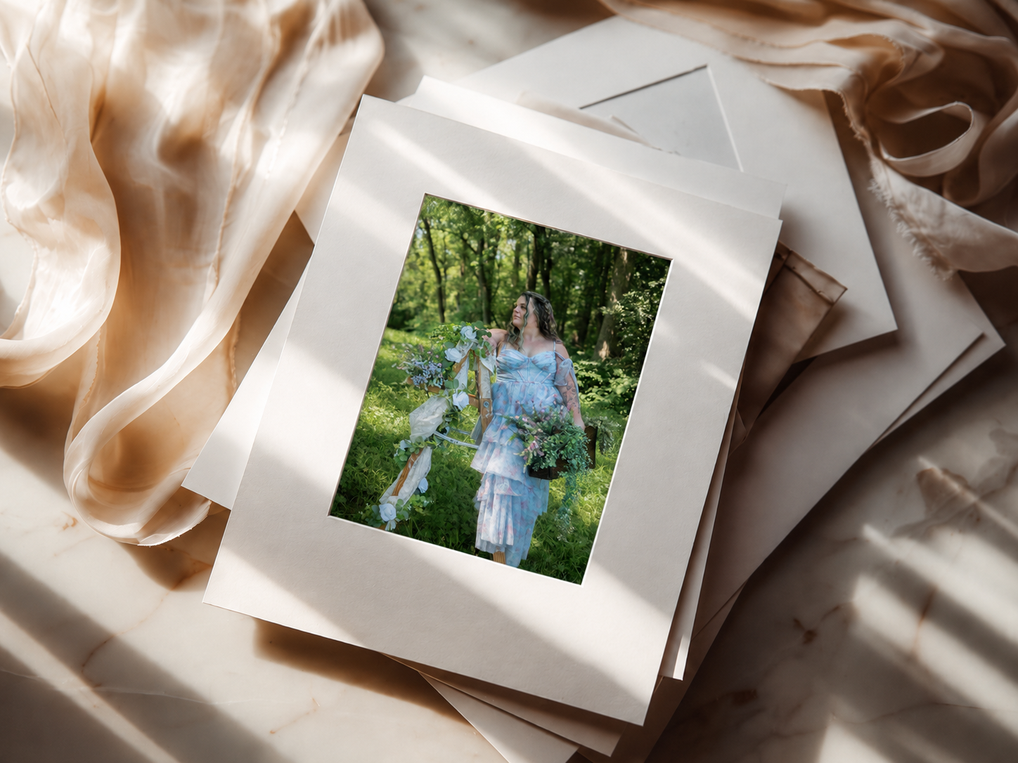 matted folio set from the in studio reveal appointment the image is a bridal portrait taken near ithaca of a woman, a ladder and flowers