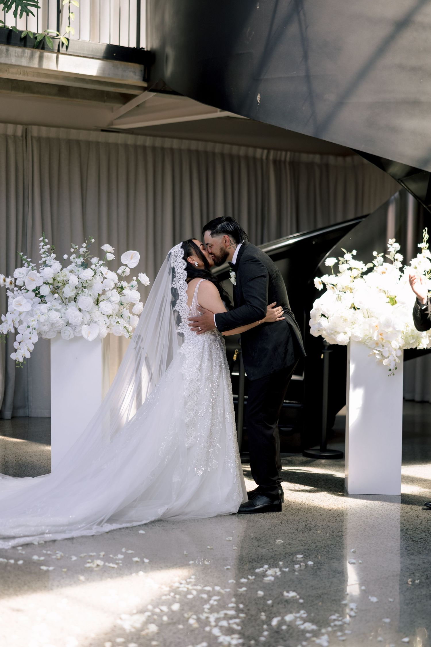 Bride and groom kissing at their indoor ceremony, Hawke's Bay wedding photographer