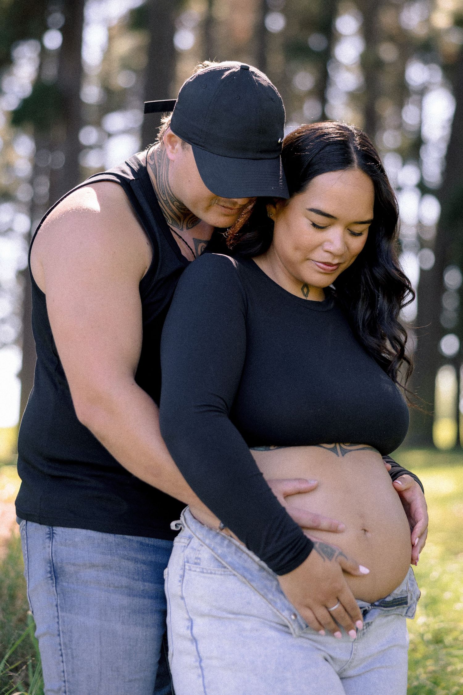 Expectant couple embracing in golden afternoon light, maternity session, Hawke's Bay photographer