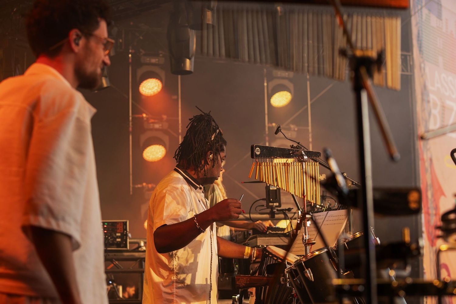 Event Photography - Musicians performing on stage under warm golden lights at an indoor concert event.