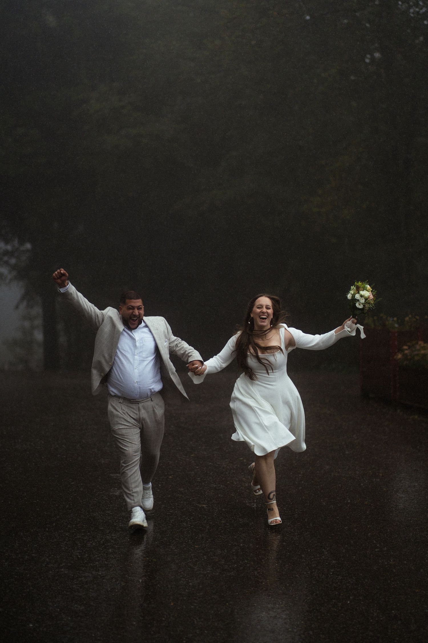 A couple runs through misty grounds celebrating their wedding day.