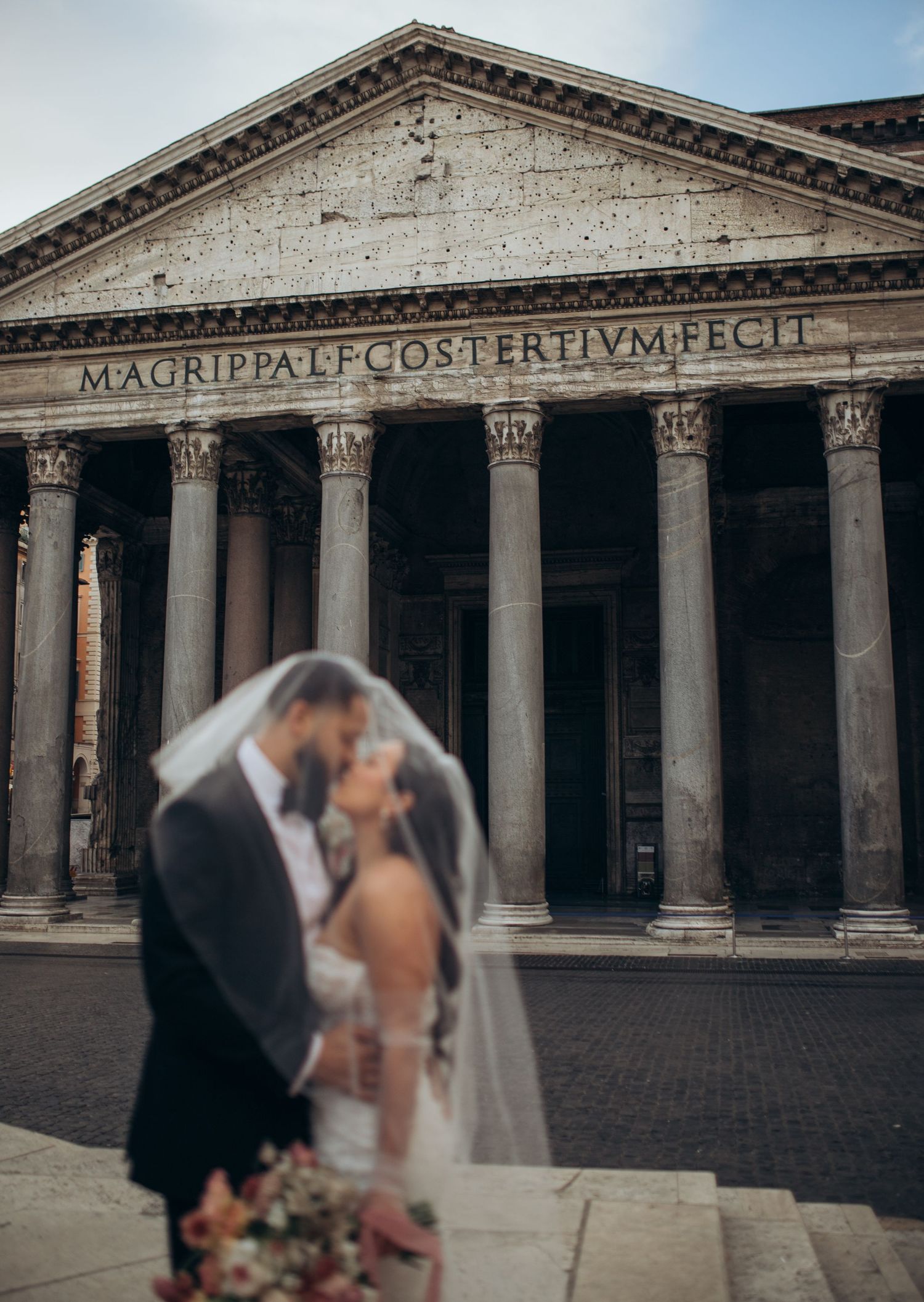 Wedding couple shares an intimate moment in front of the historic Pantheon in Rome, Italy.