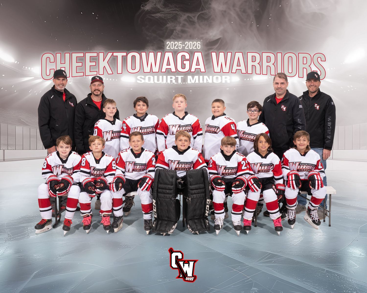 Youth hockey team in red and white jerseys poses together on the ice for team photos.