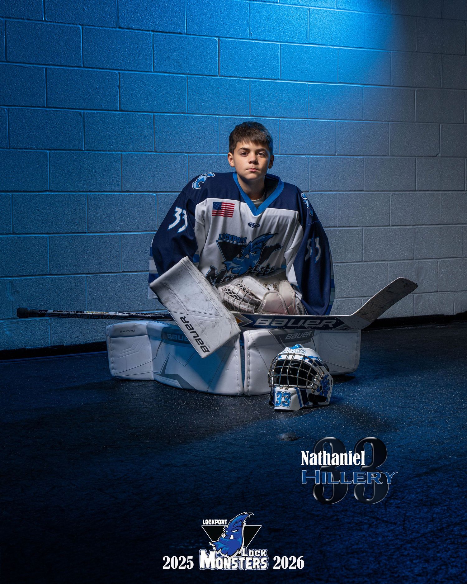Hockey player in blue lighting poses with gear and equipment for dramatic sports portrait series.