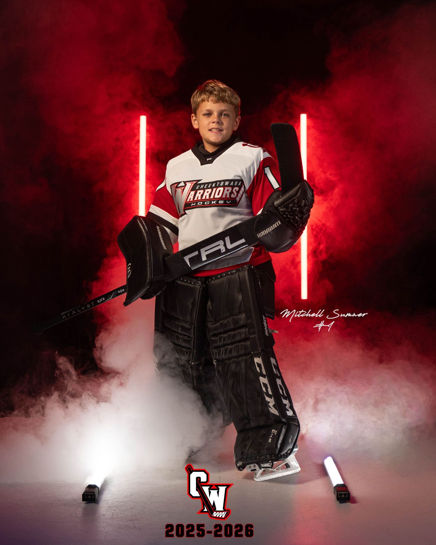 A youth hockey player poses in dramatic red lighting and fog effects for a sports portrait series.