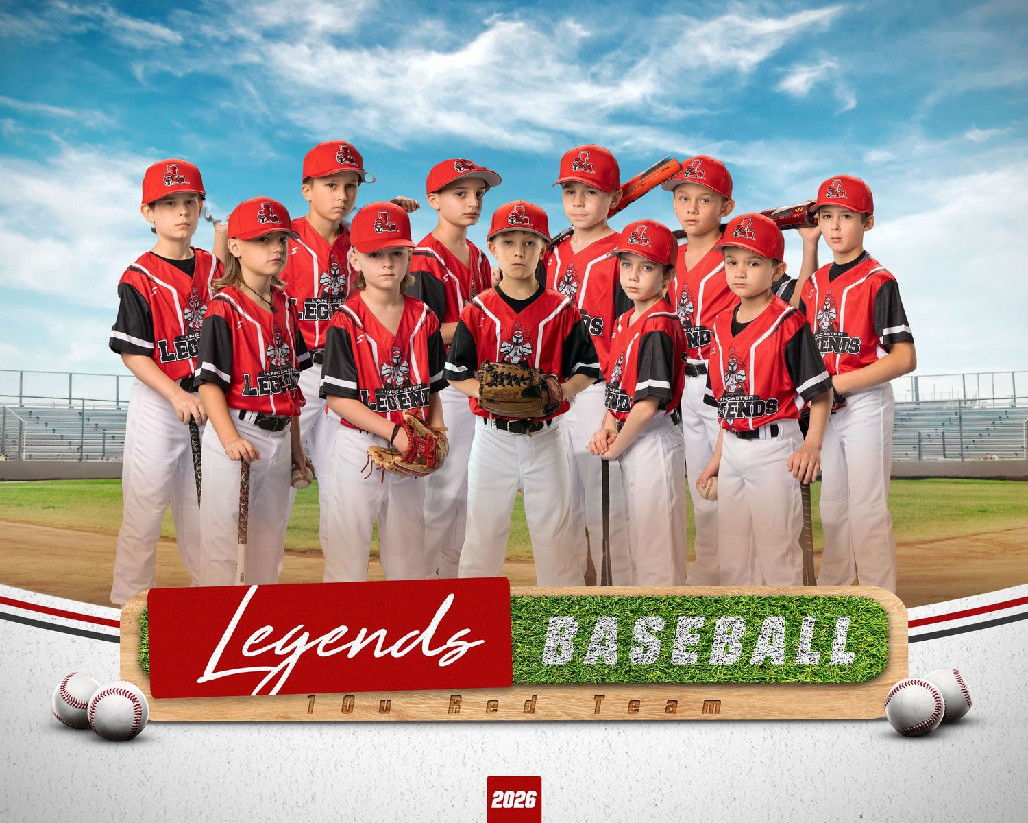 Youth baseball team in red and black uniforms poses together on field for team photo under blue sky.