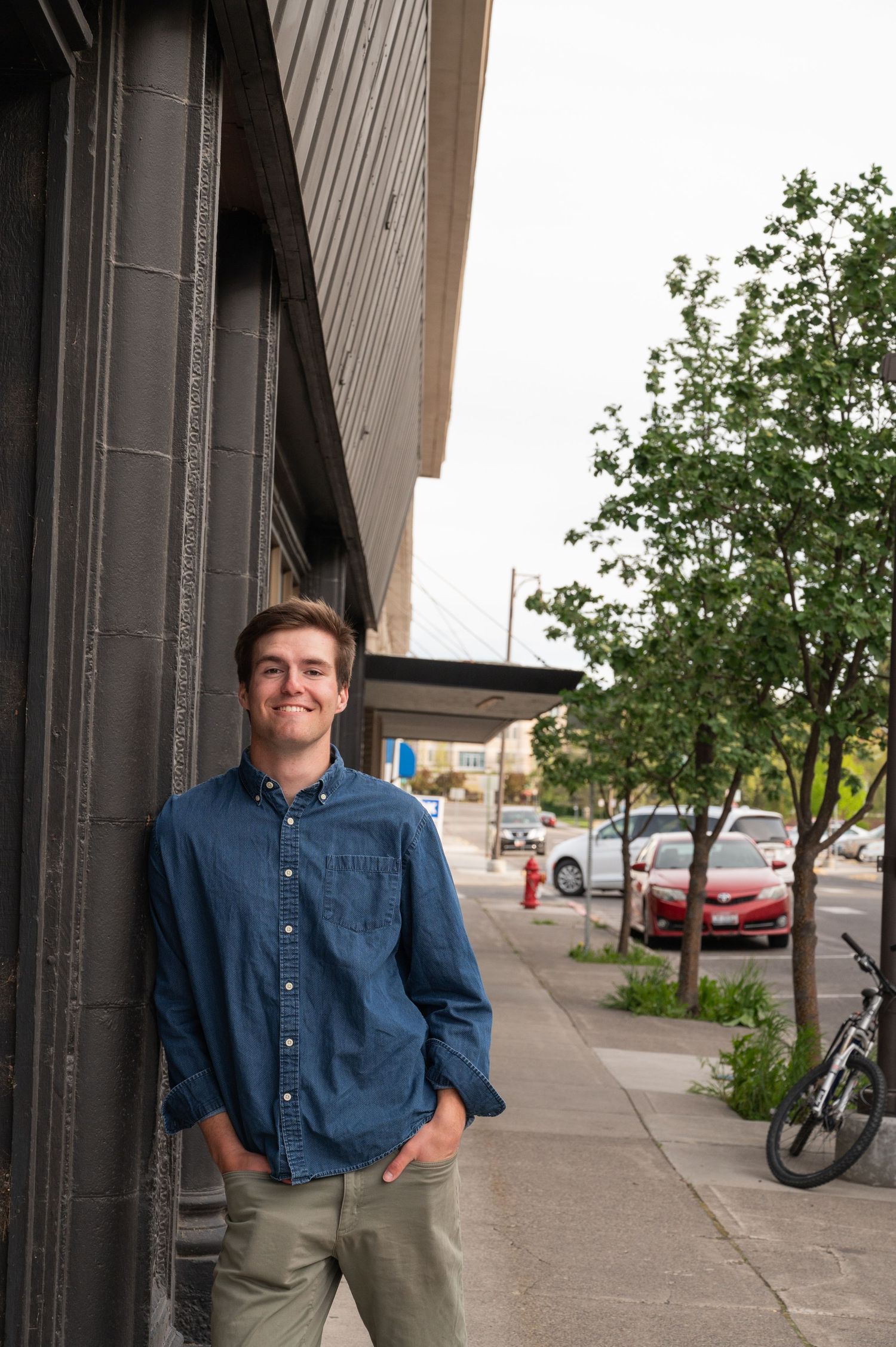 man leaning against building