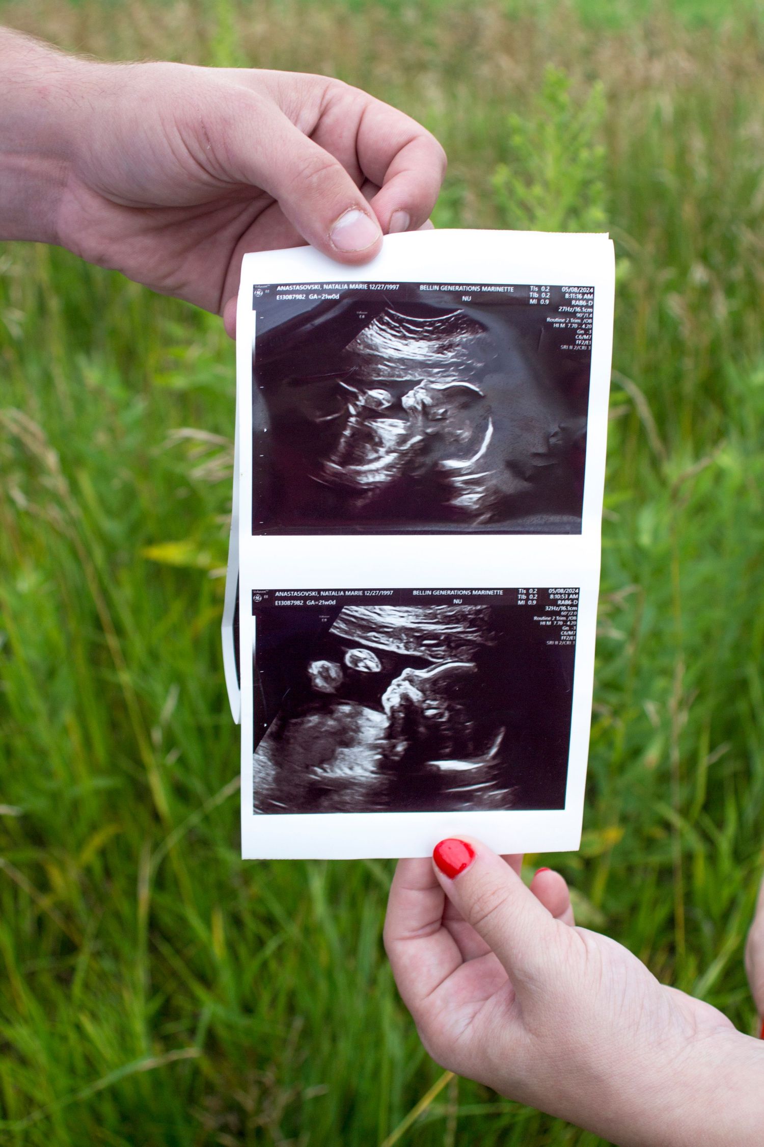 Maternity photo of a man and women holding an ultrasound.