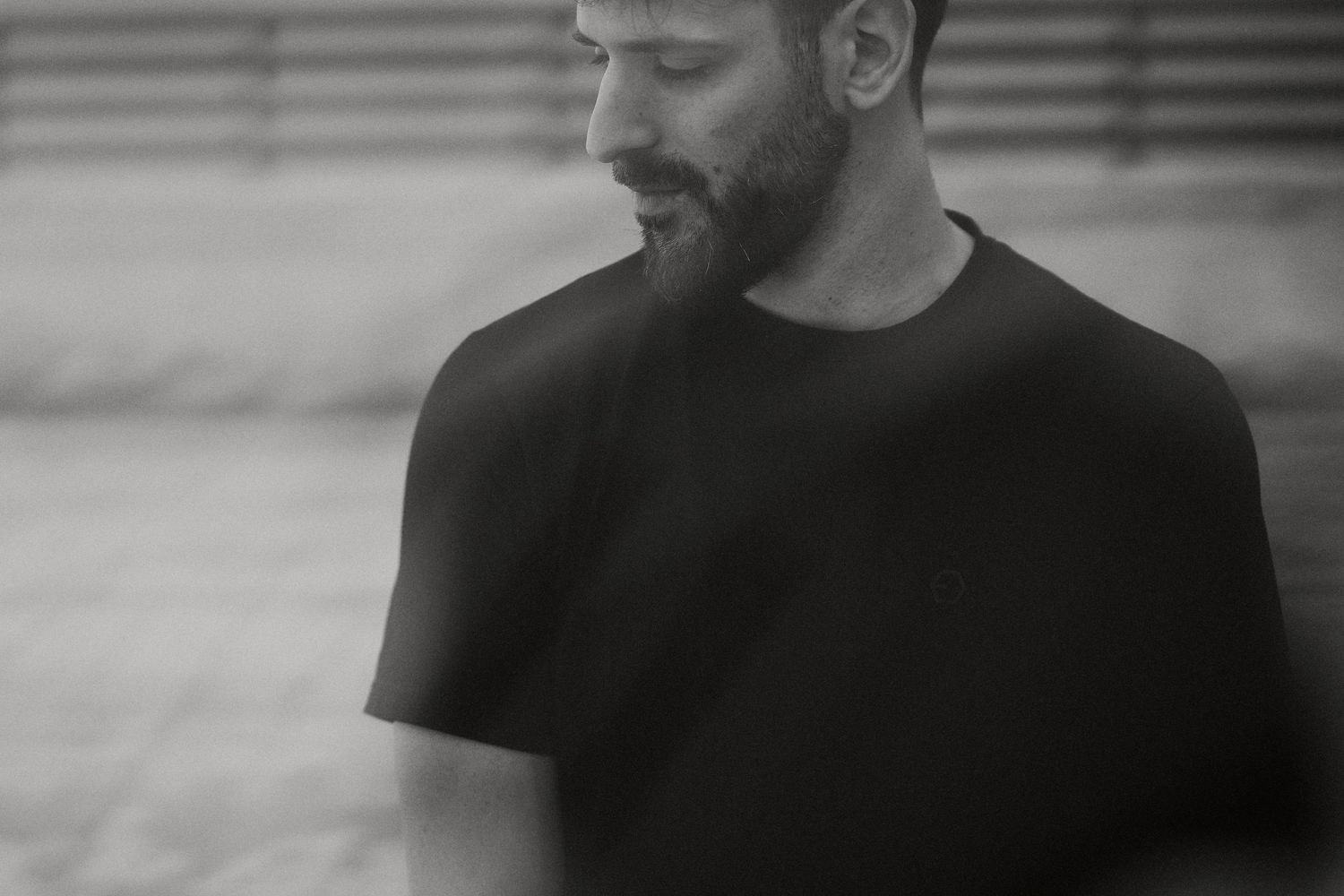 Close-up black and white portraits showing different angles of a person in casual attire.