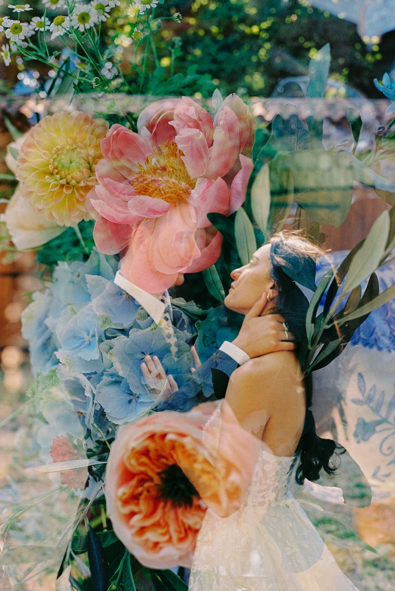 Double exposure wedding photo blending couple embracing with vibrant pink peonies, hydrangeas, and lush garden florals.