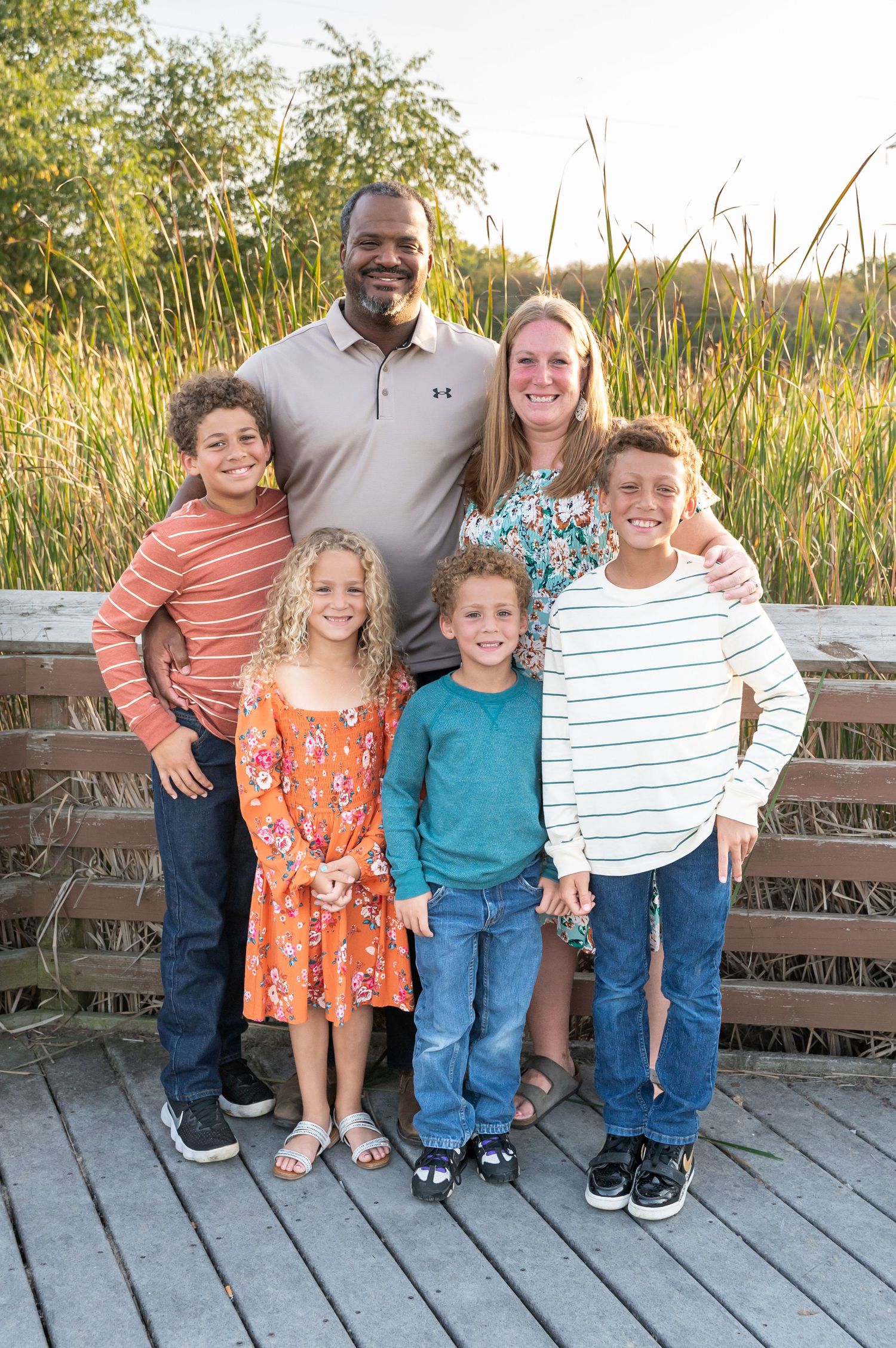 family fall photo on a boardwalk