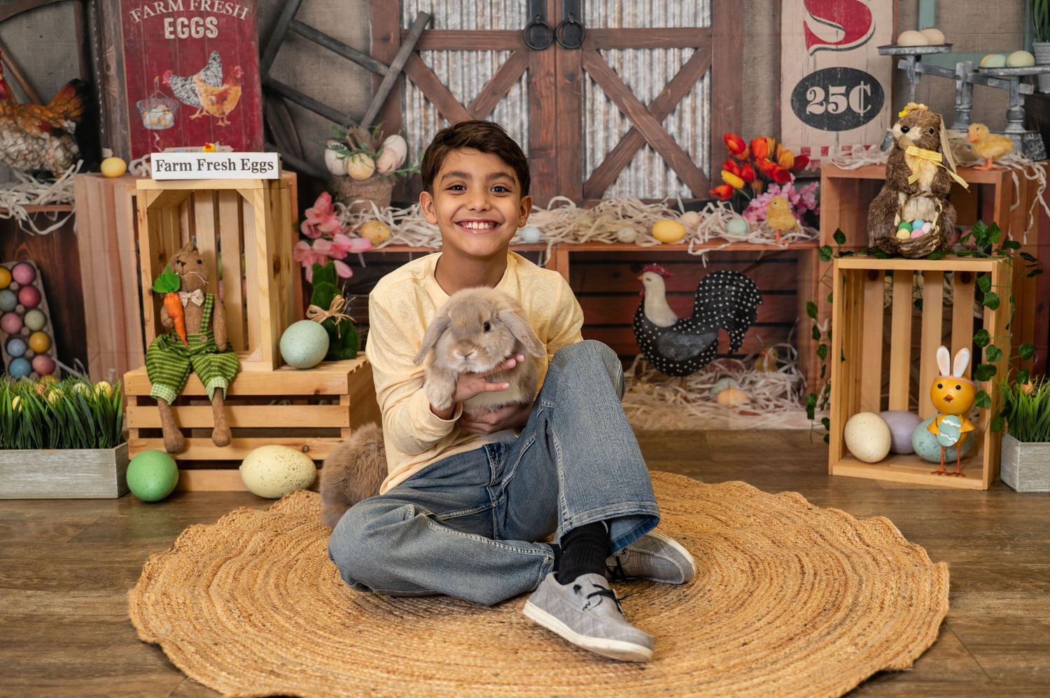 A young person sits cross-legged on a round jute rug with Easter decorations and wooden crates in the background.