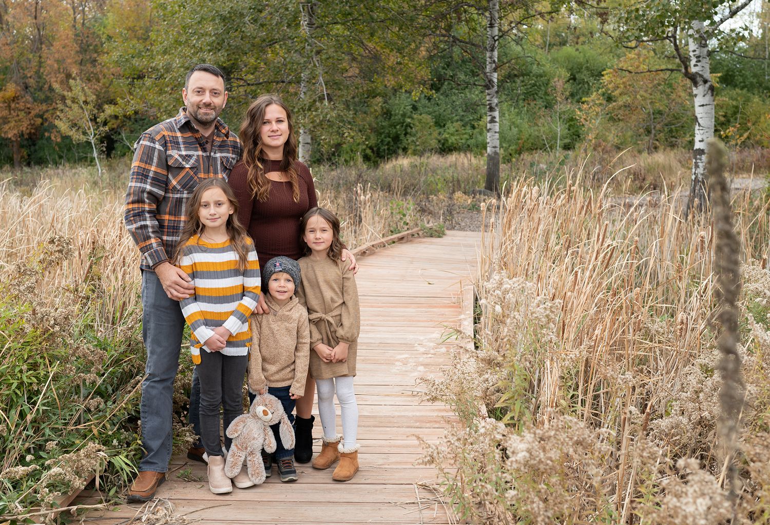 family standing bridge