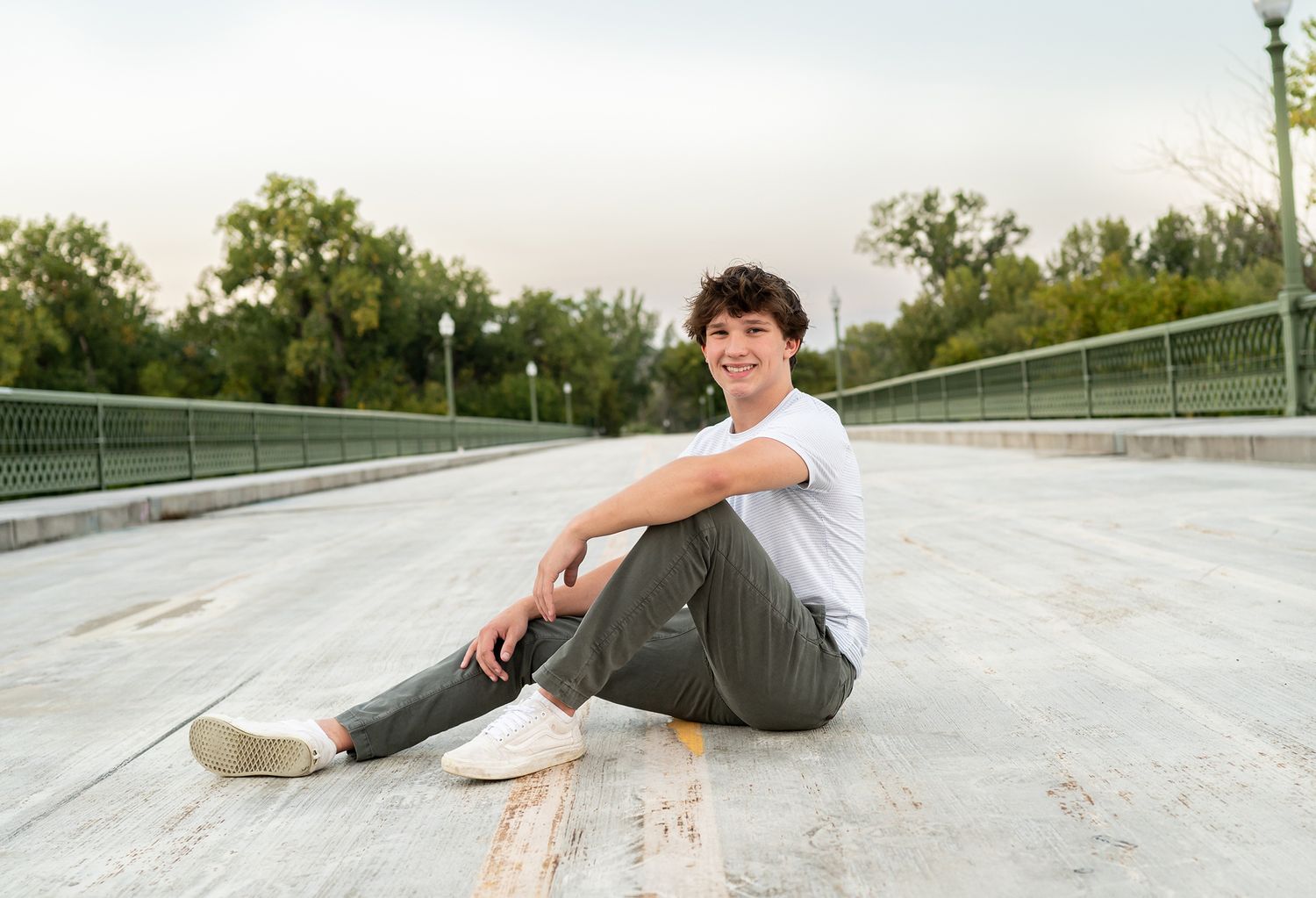 senior boy on road bridge