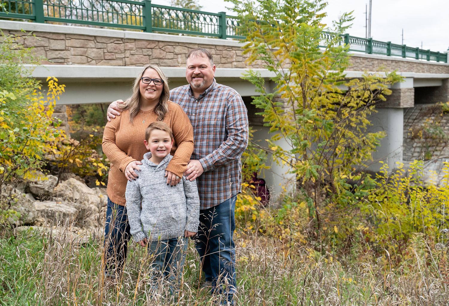 family by bridge and water