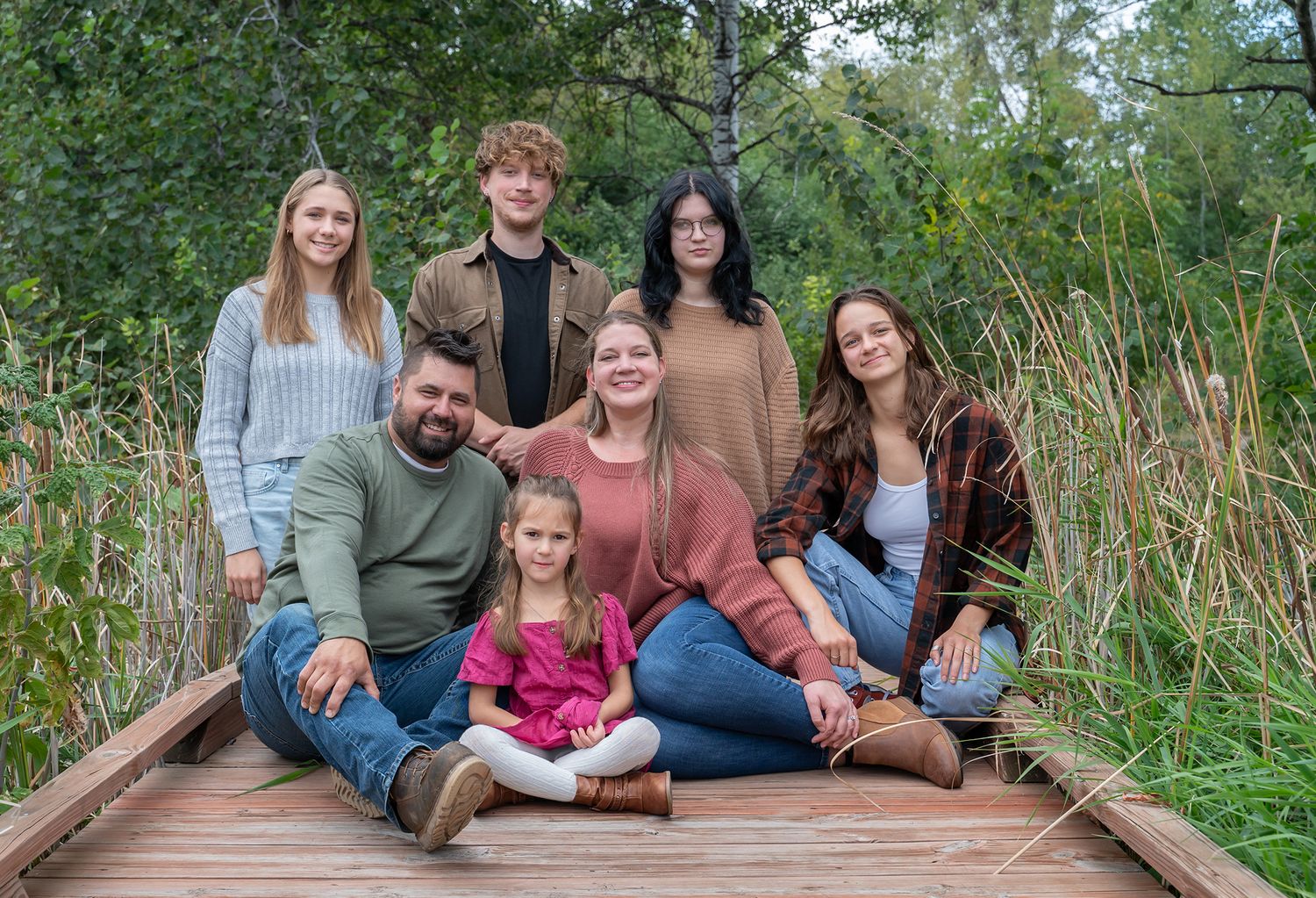 larger family sitting on bridge