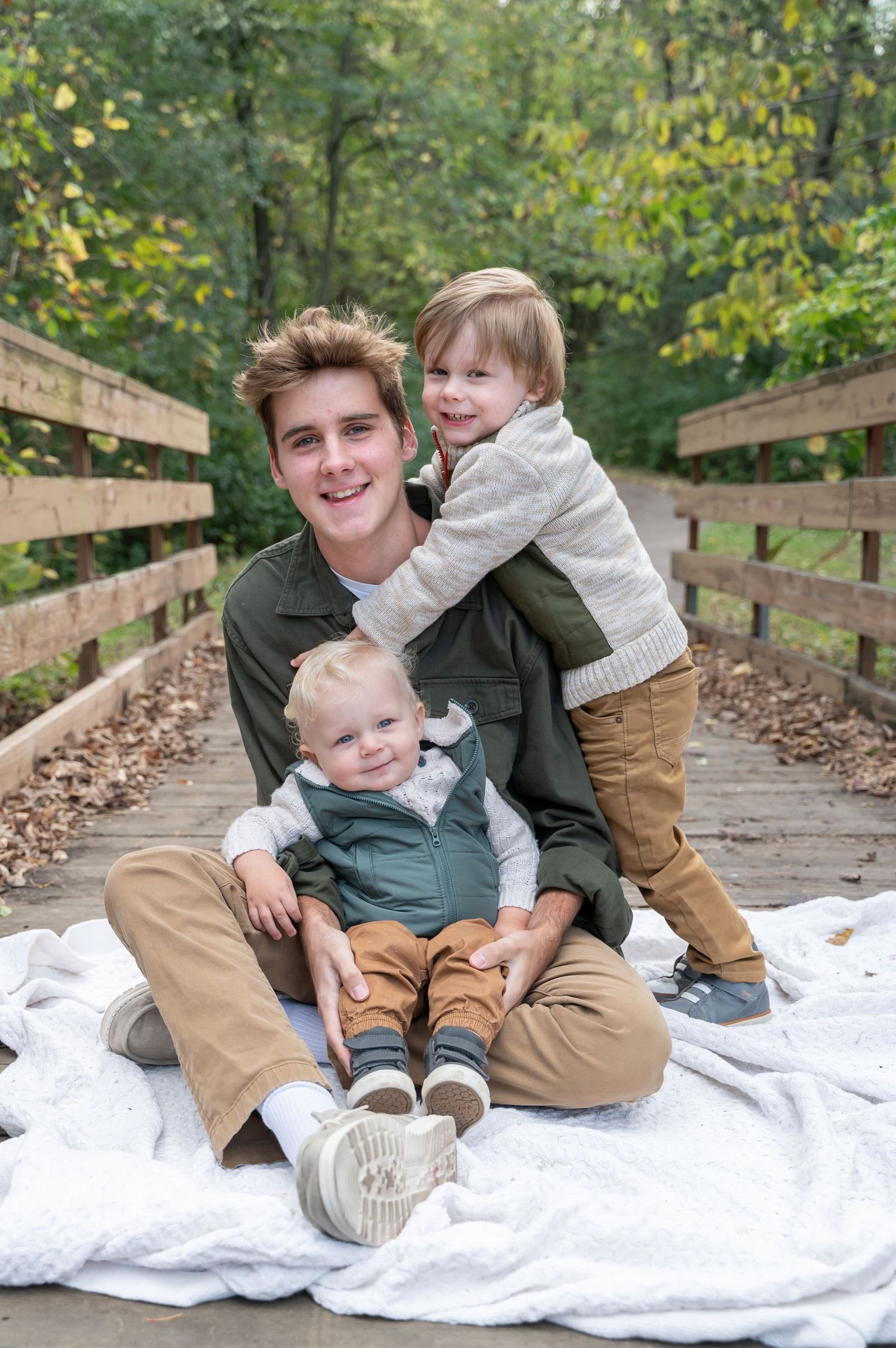 brothers playing together on a bridge