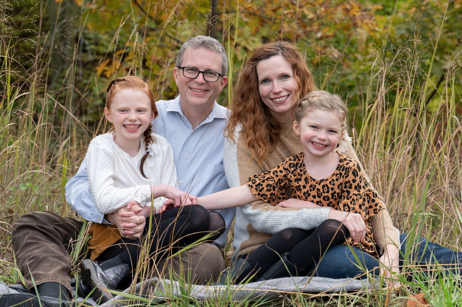 family photo sitting in a field