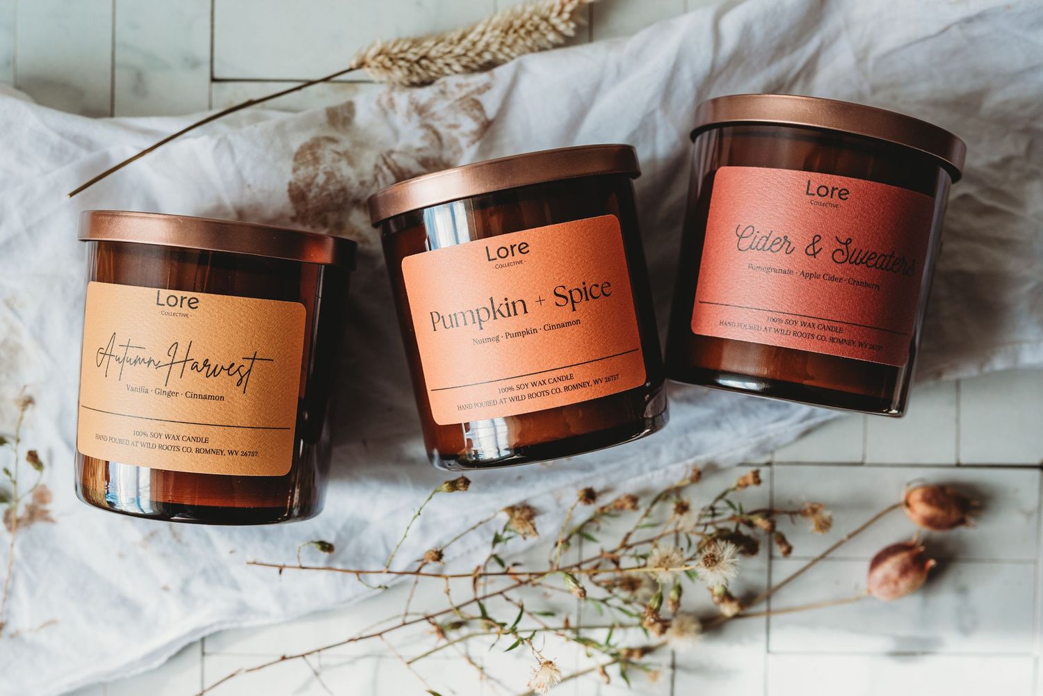 Collection of brown wooden skincare product jars arranged on marble countertop.