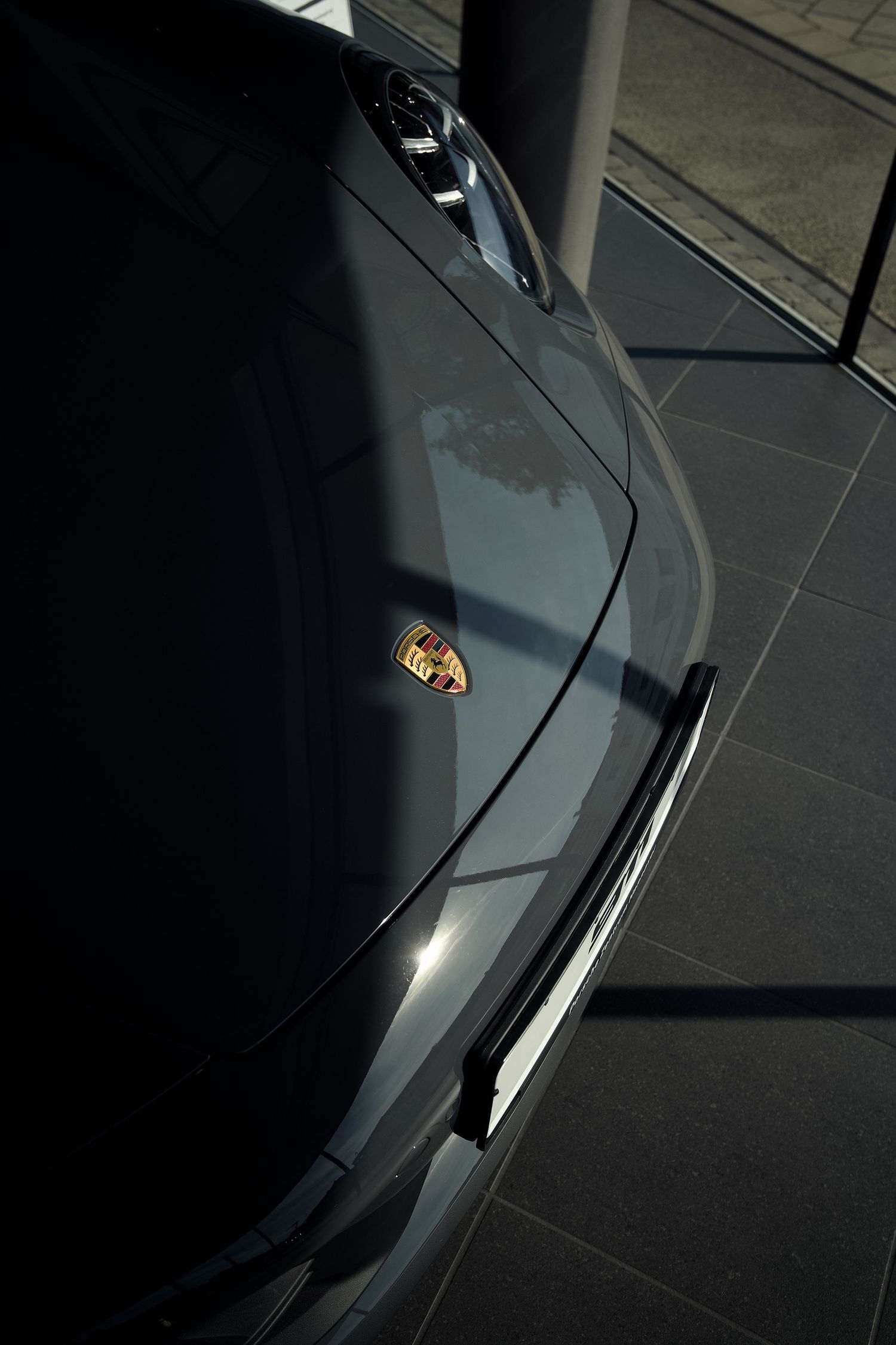 A sleek black Lamborghini Aventador photographed from above showing its angular design and dramatic lines.