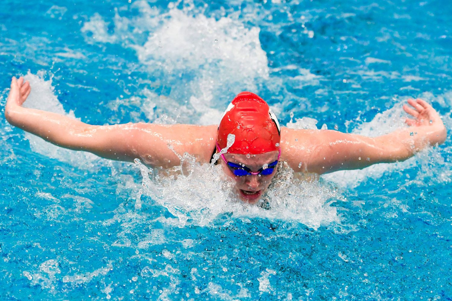 Swimmer coming out of the water during the butterfly stroke