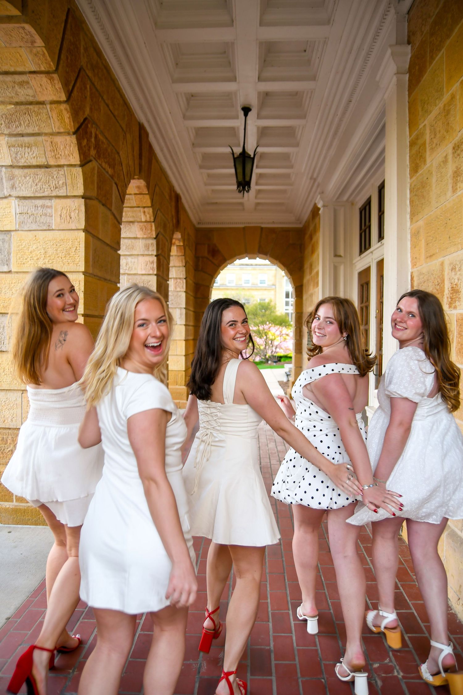 Group of girls smiling and laughing running away
