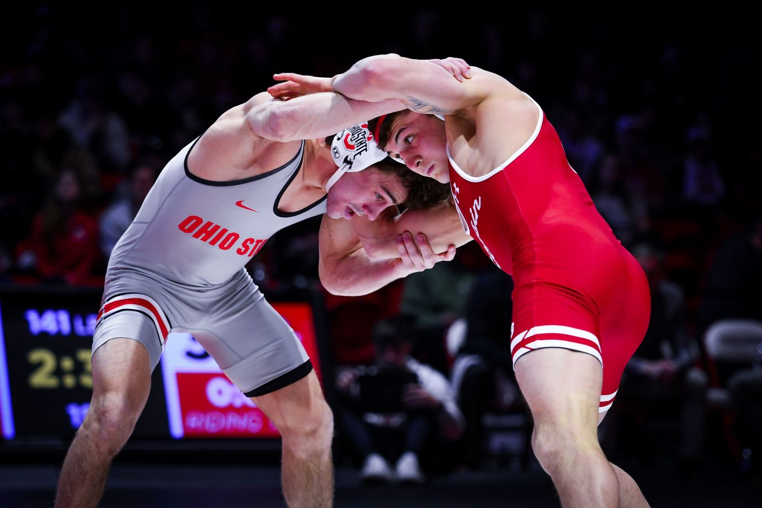 Wrestlers mid-wrestle locking arms