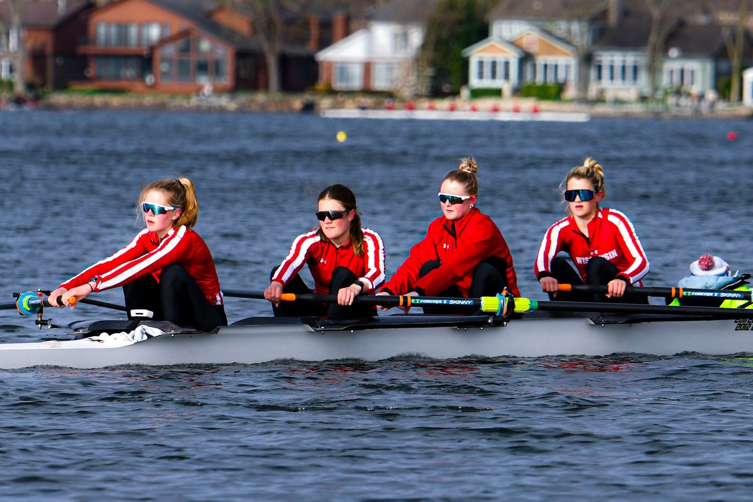 Four rowers at the catch of the stroke on the water