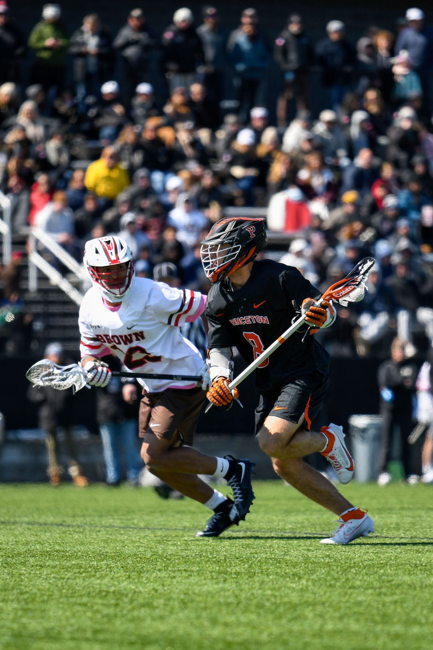 Two lacrosse players running