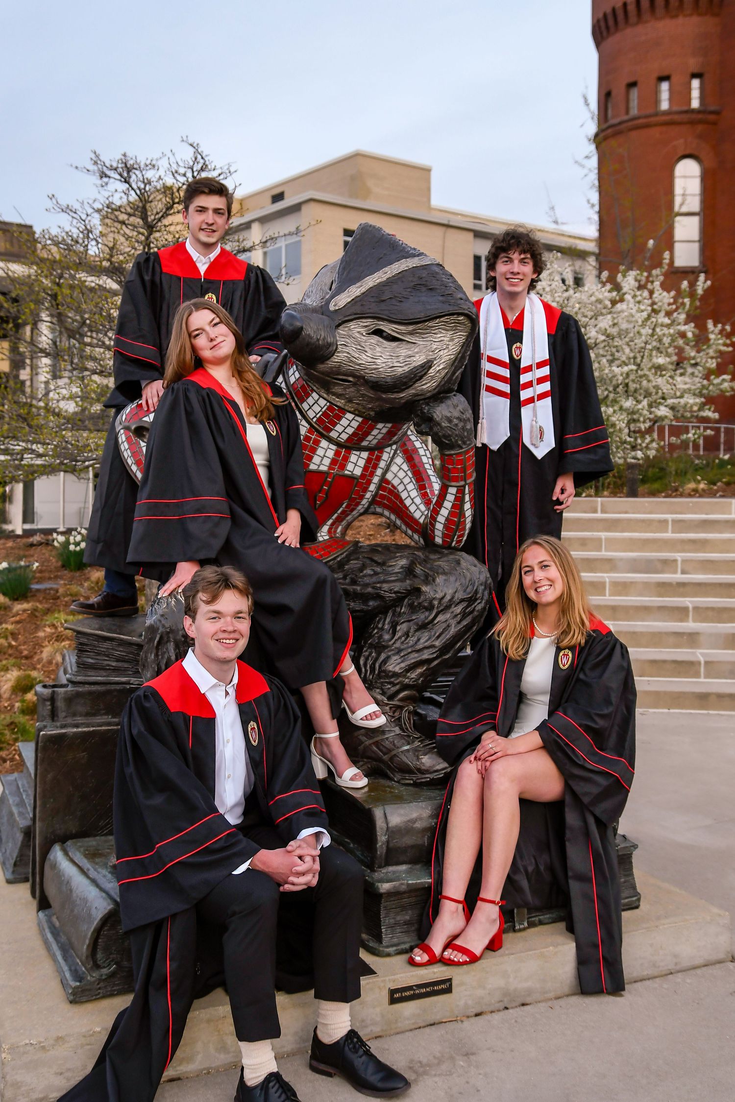 People sitting on a statue of Bucky