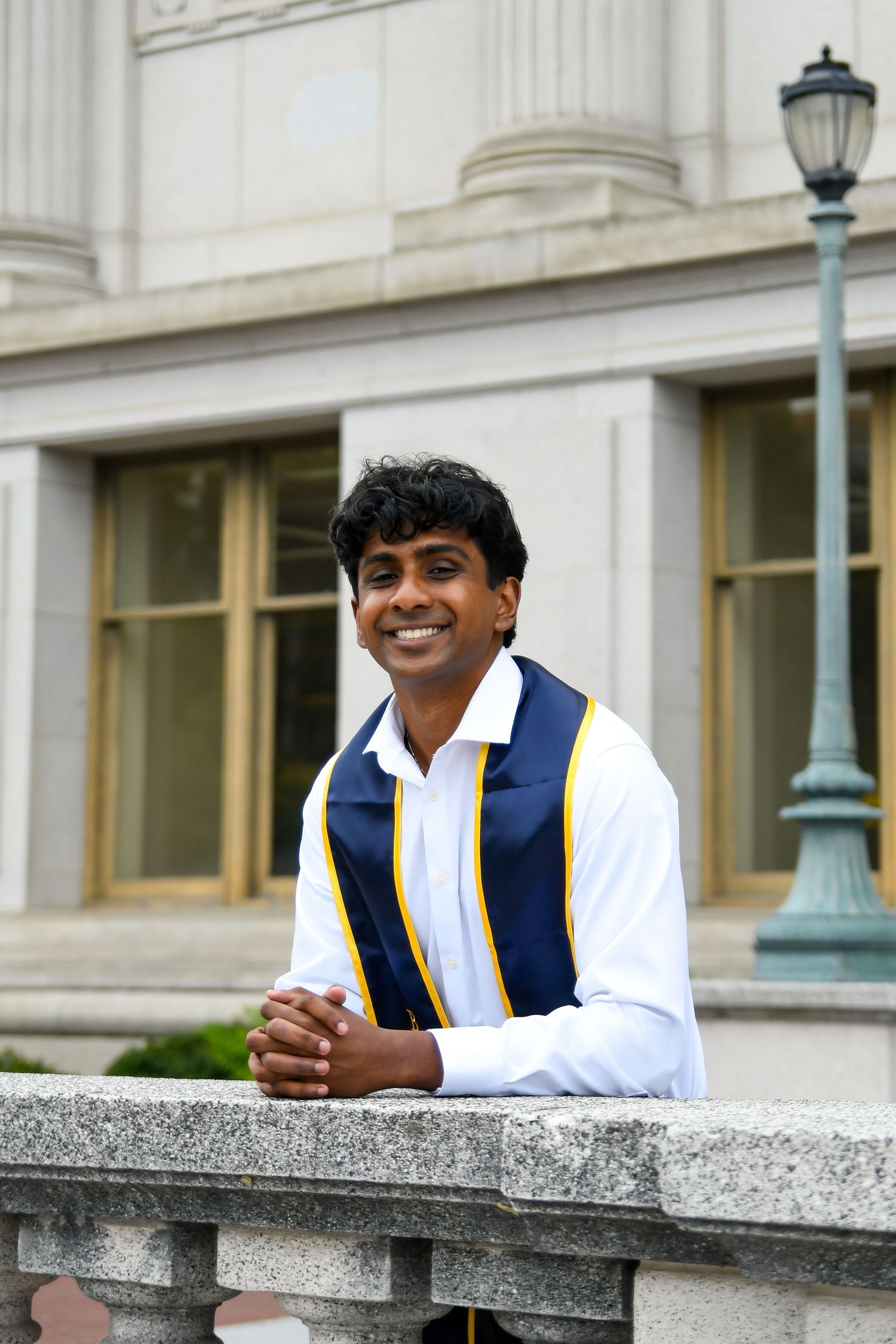 Man smiling and leaning on ledge