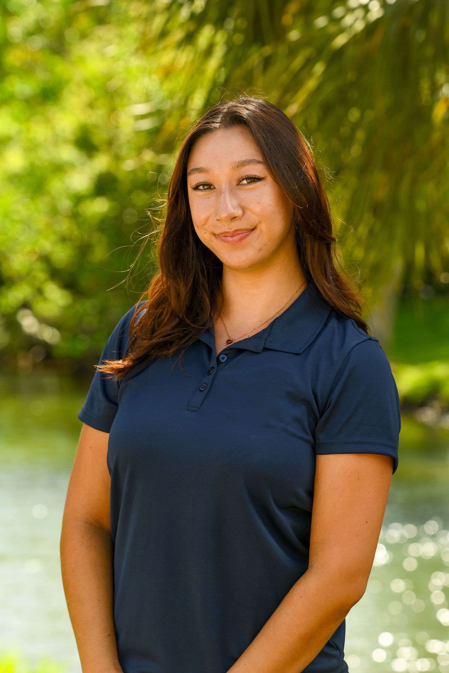 Girl smiling surrounded by palm trees