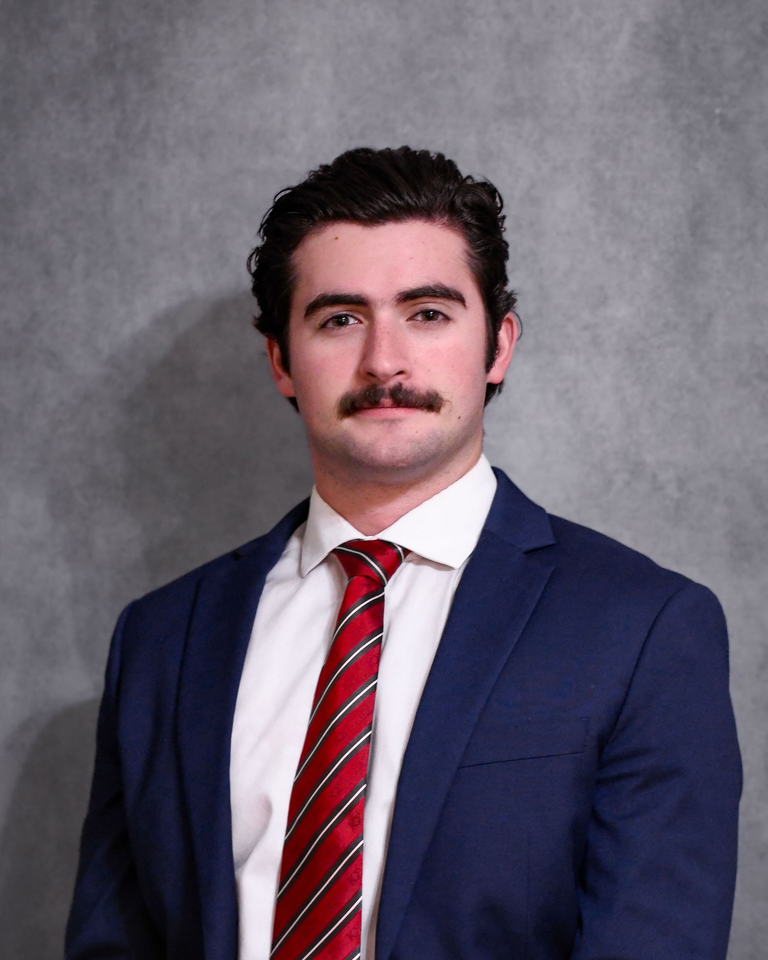 Headshot of man in suit and tie
