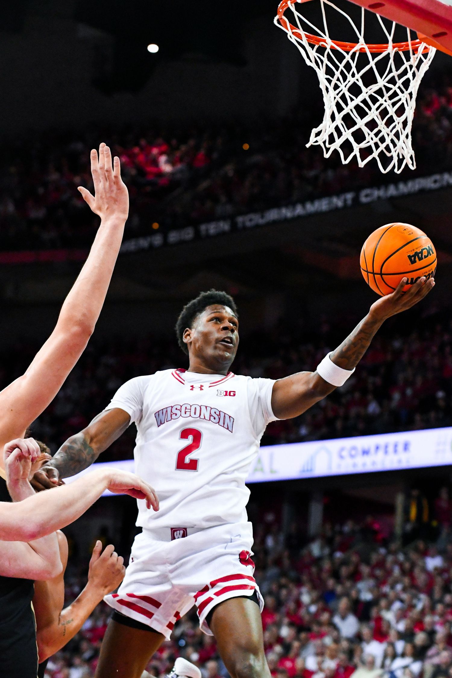 Male basketball player jumps up to shoot the ball