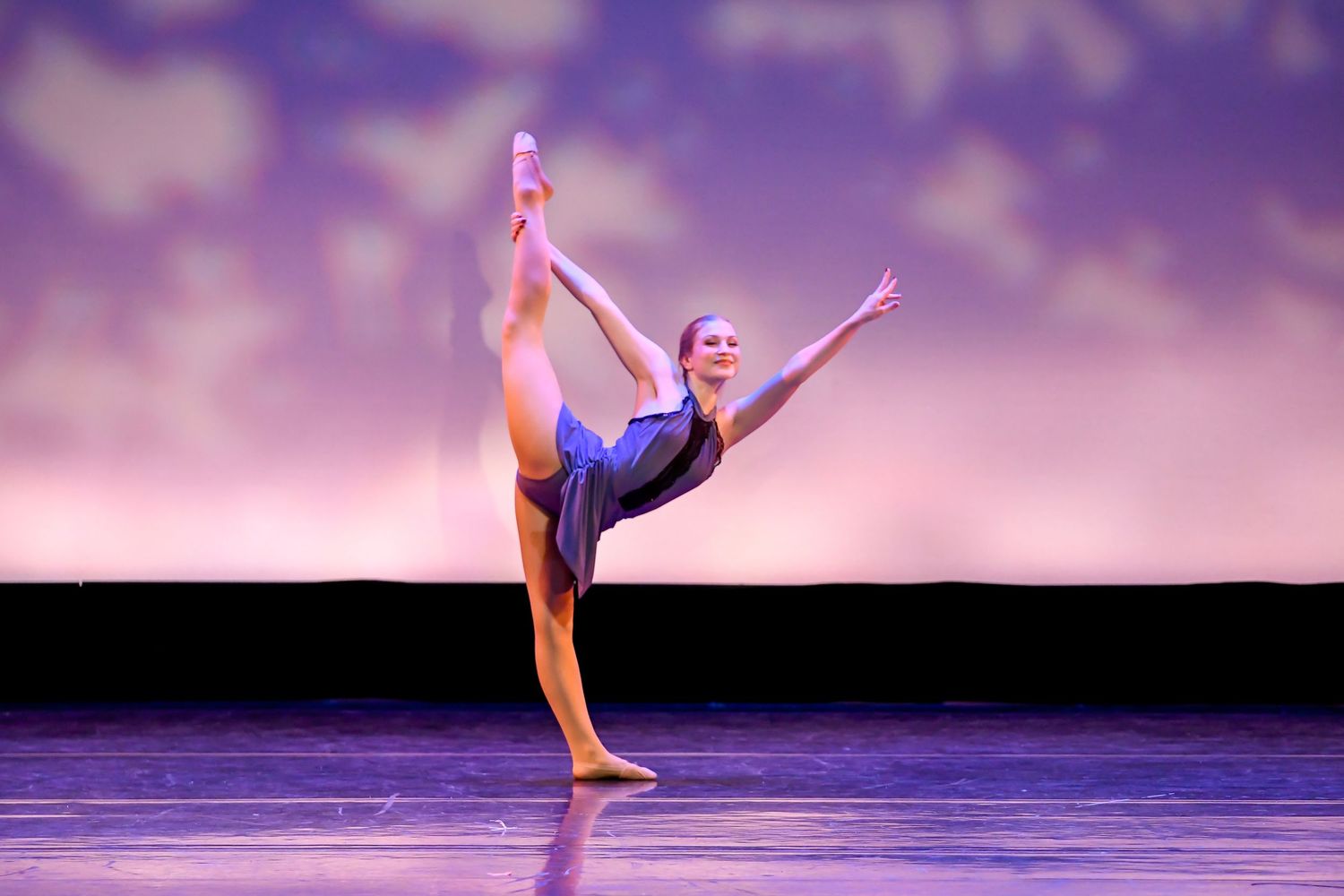 Female dancer kicks her leg up