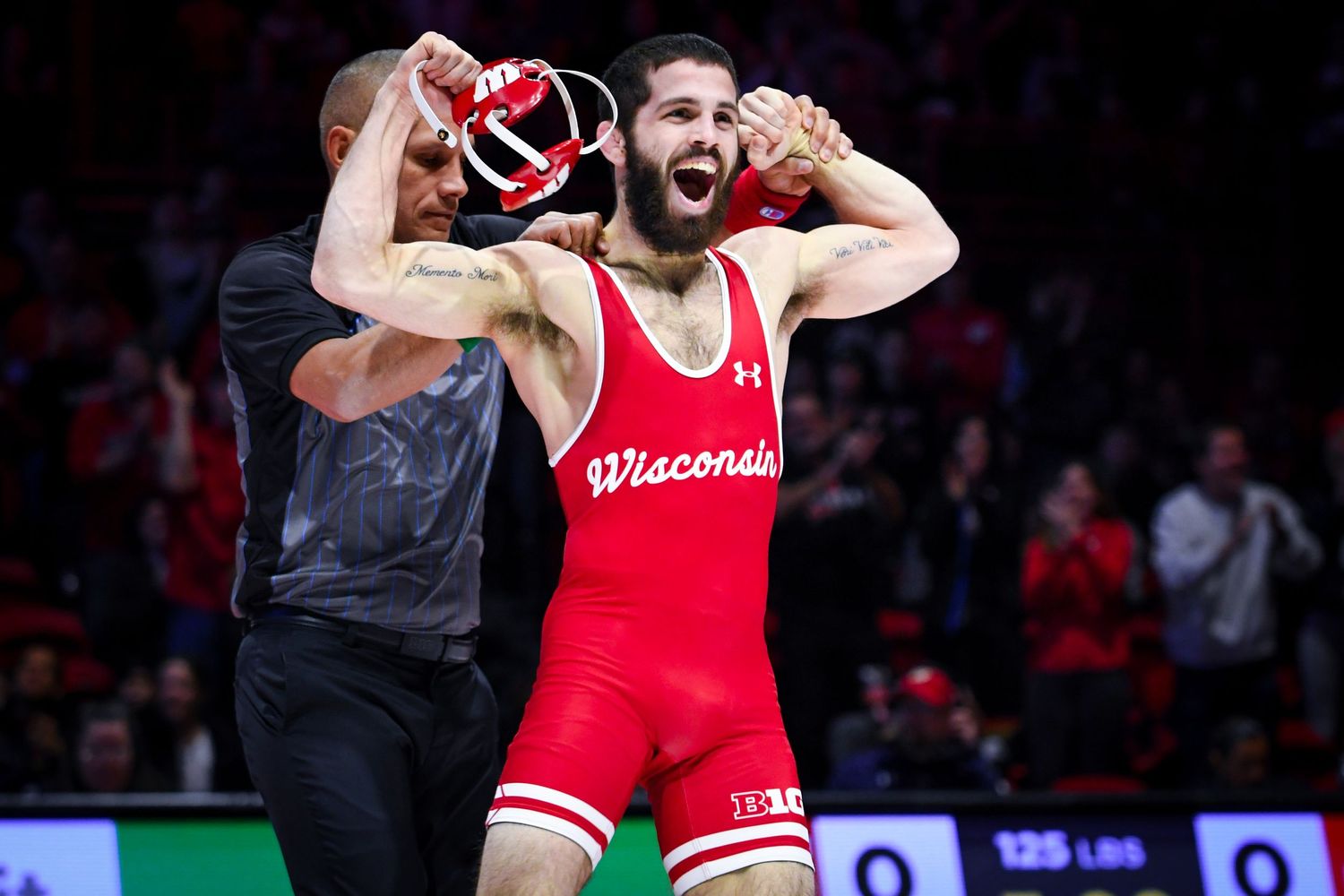 Wrestler flexes his arms towards the crowd
