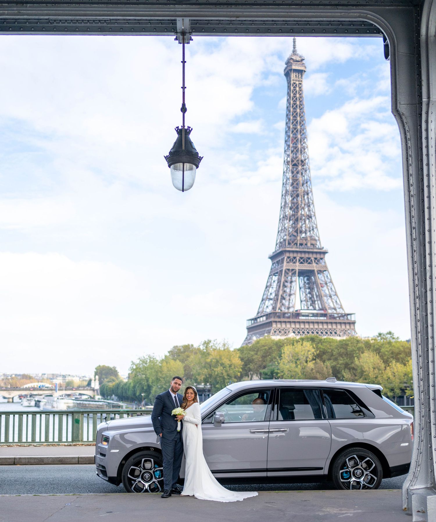 Panoramic view of Paris with Eiffel Tower and luxury car in foreground.