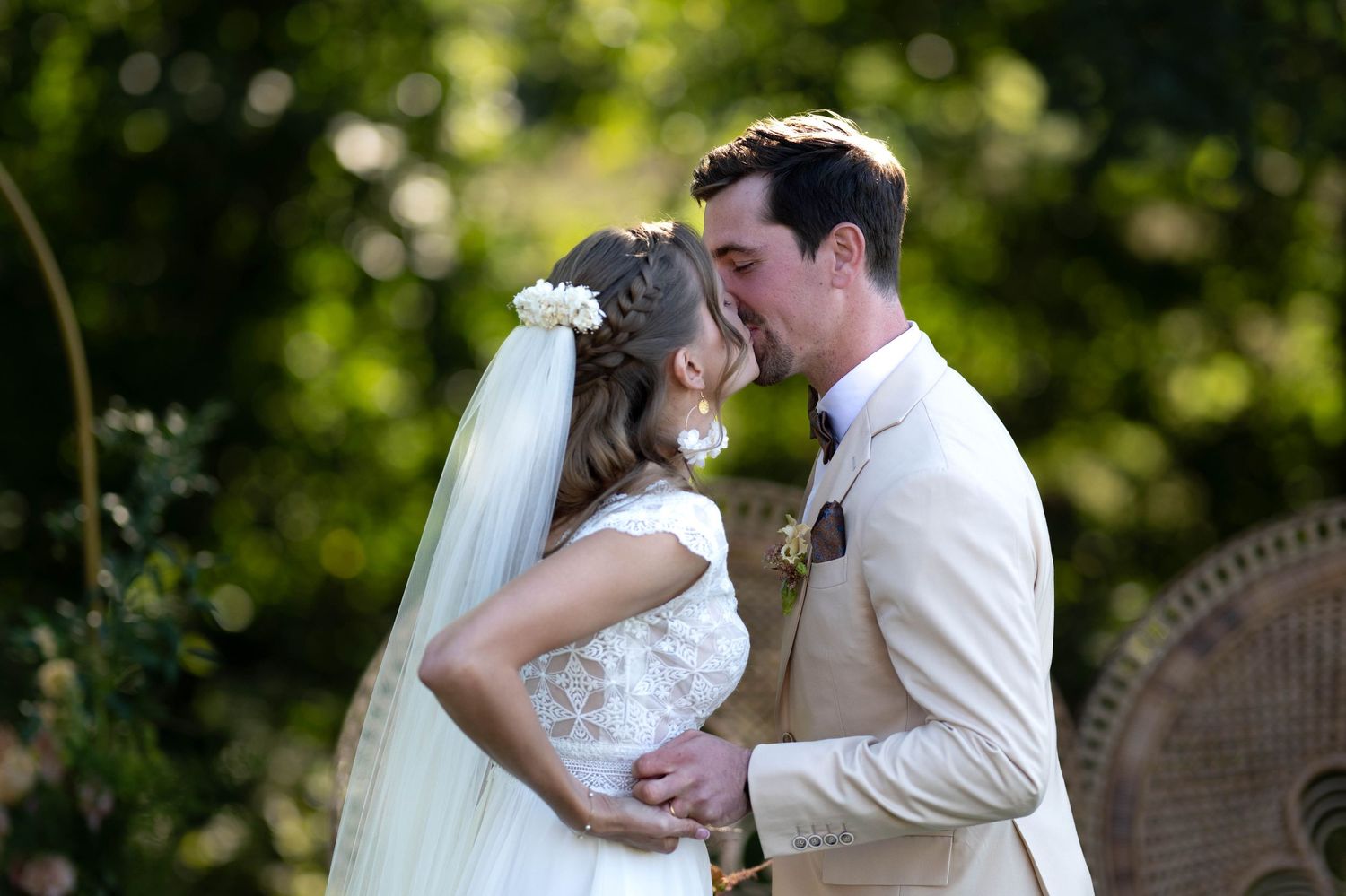 Wedding couple shares intimate moments in a lush garden setting.