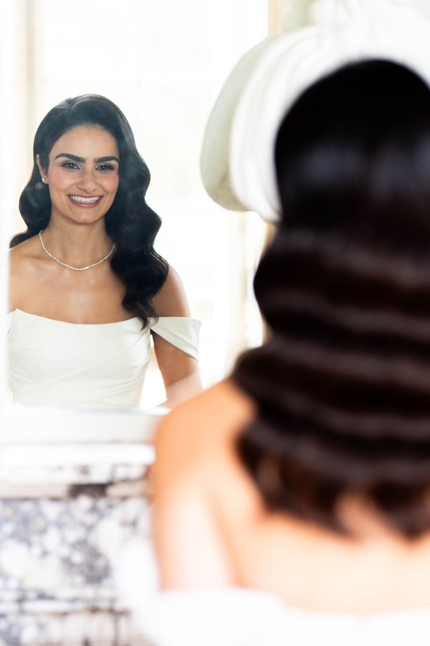 A sequence of blurred wedding photos showing someone in a white dress with dark hair and jewelry.