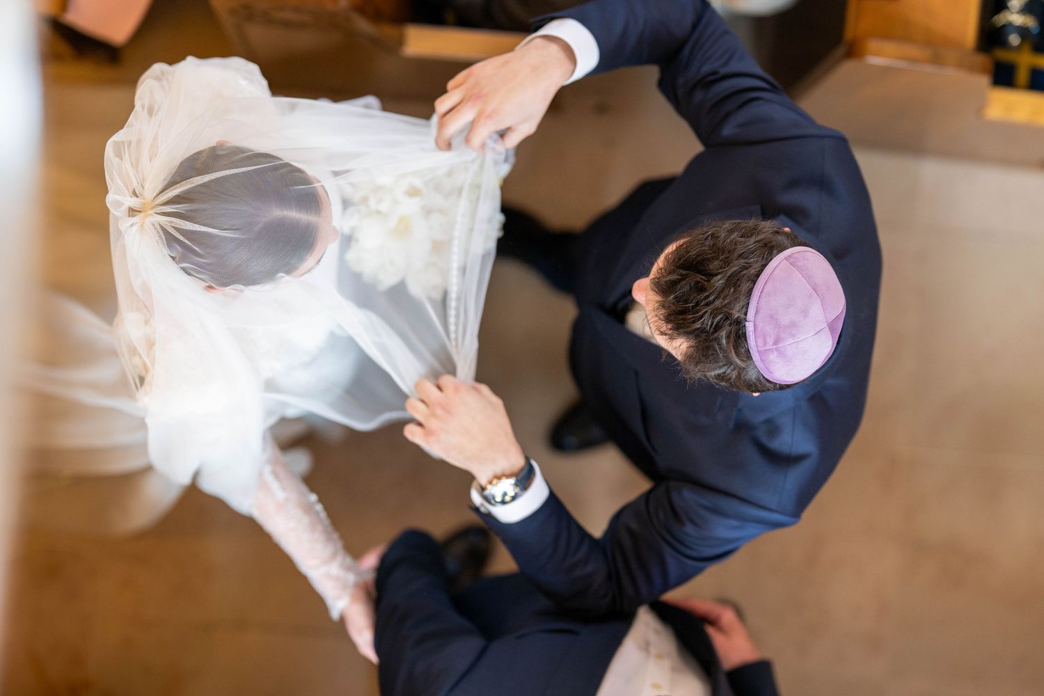 Tender wedding ceremony moments captured under traditional Jewish wedding canopy.