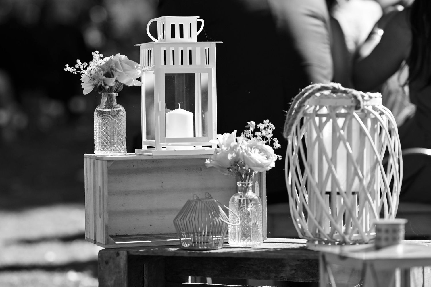 Wedding reception decor featuring white lanterns and delicate table arrangements.