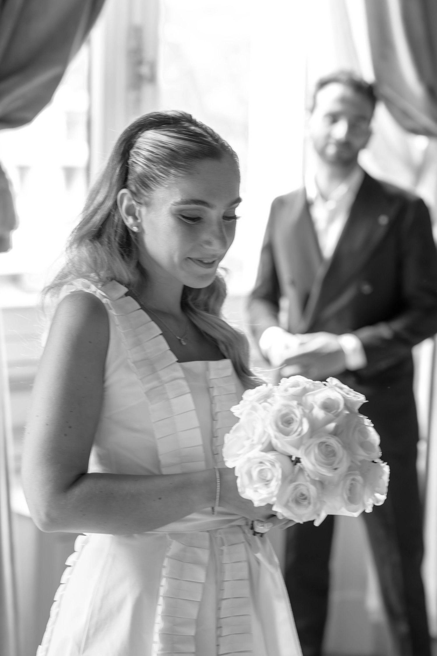 A sequence of black and white wedding photos showing a bride in a white dress holding a bouquet of roses.