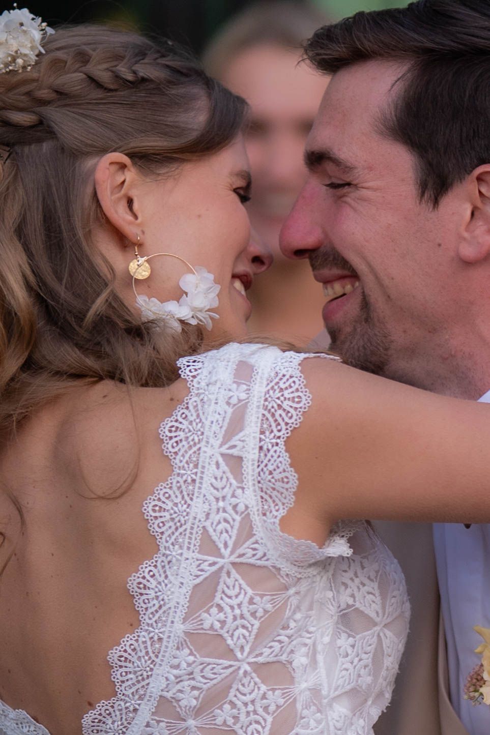 A romantic close-up series showing a couple sharing tender moments in wedding attire with delicate white lace details.