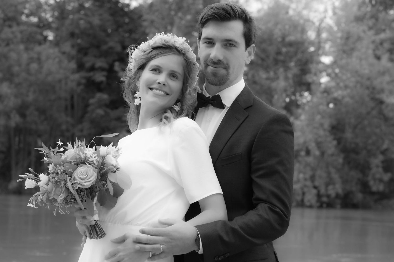 A black and white wedding photo collage showing intimate moments between a couple in an outdoor garden setting.