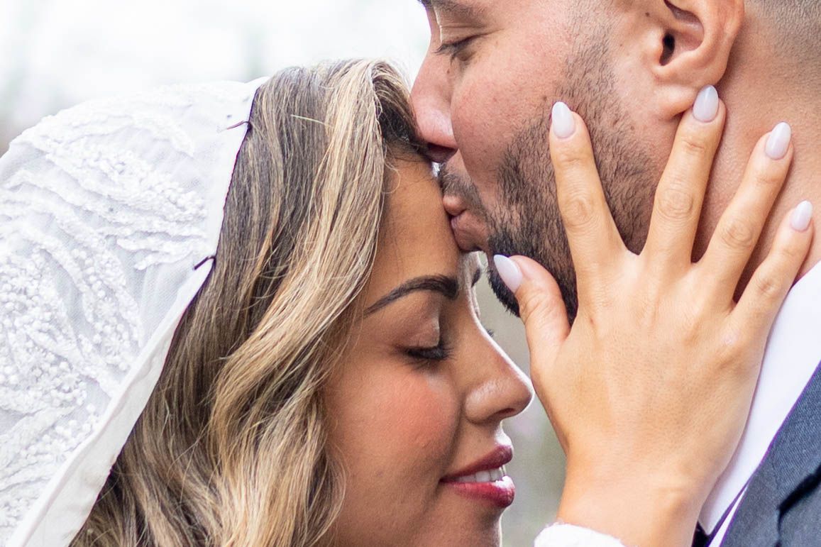Close-up romantic photos of a bride and groom sharing intimate moments during their wedding photoshoot.