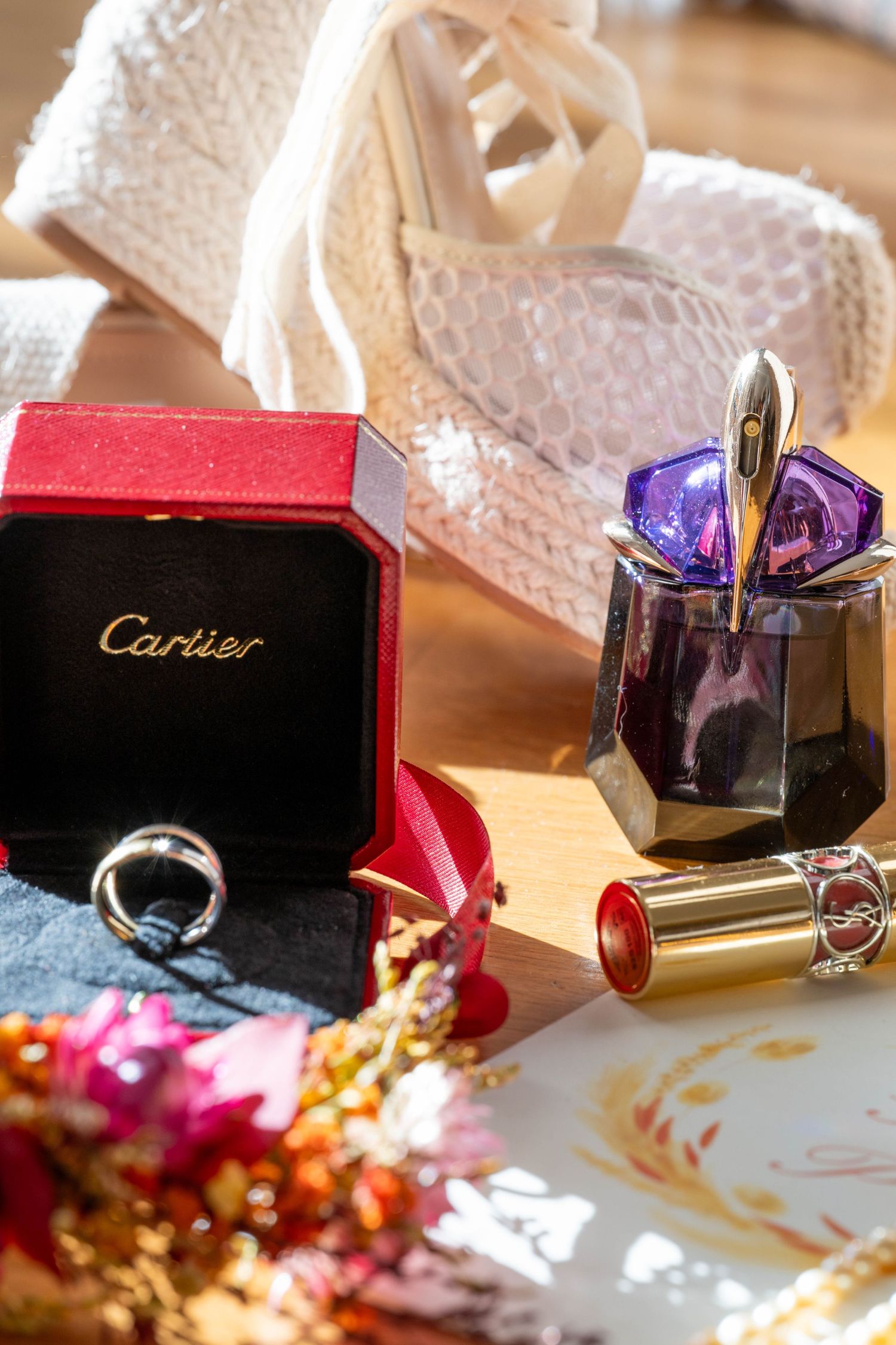Luxury Cartier jewelry box with red and gold accents displayed with decorative elements.