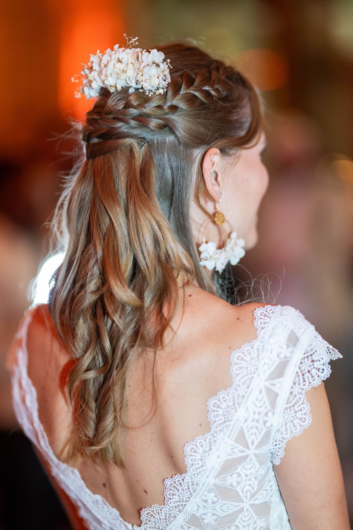 Intricate lace details and braided hairstyle with crystal accessories.