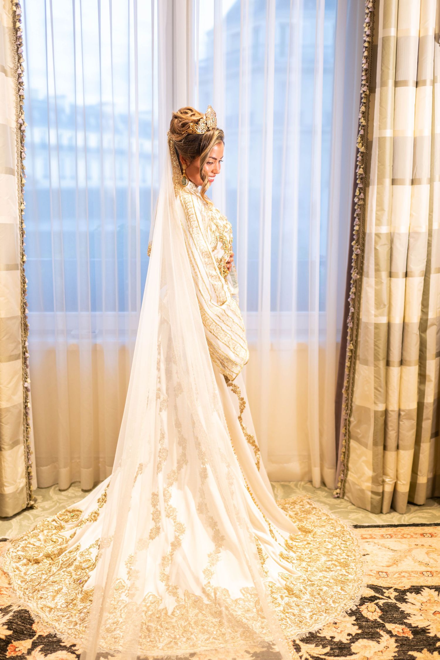Elegant bridal portraits showing flowing lace wedding gown with cathedral length train in natural light.